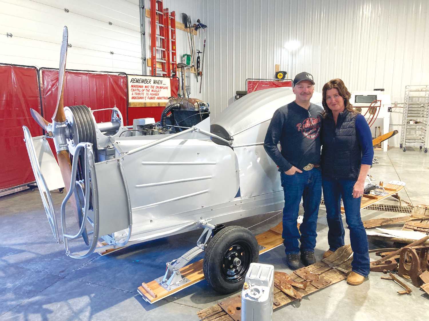Darrell Hunter and Lisl Gunderman with the restored Fudge Snowplane that will be the focus of the Moosomin Parade this summer.